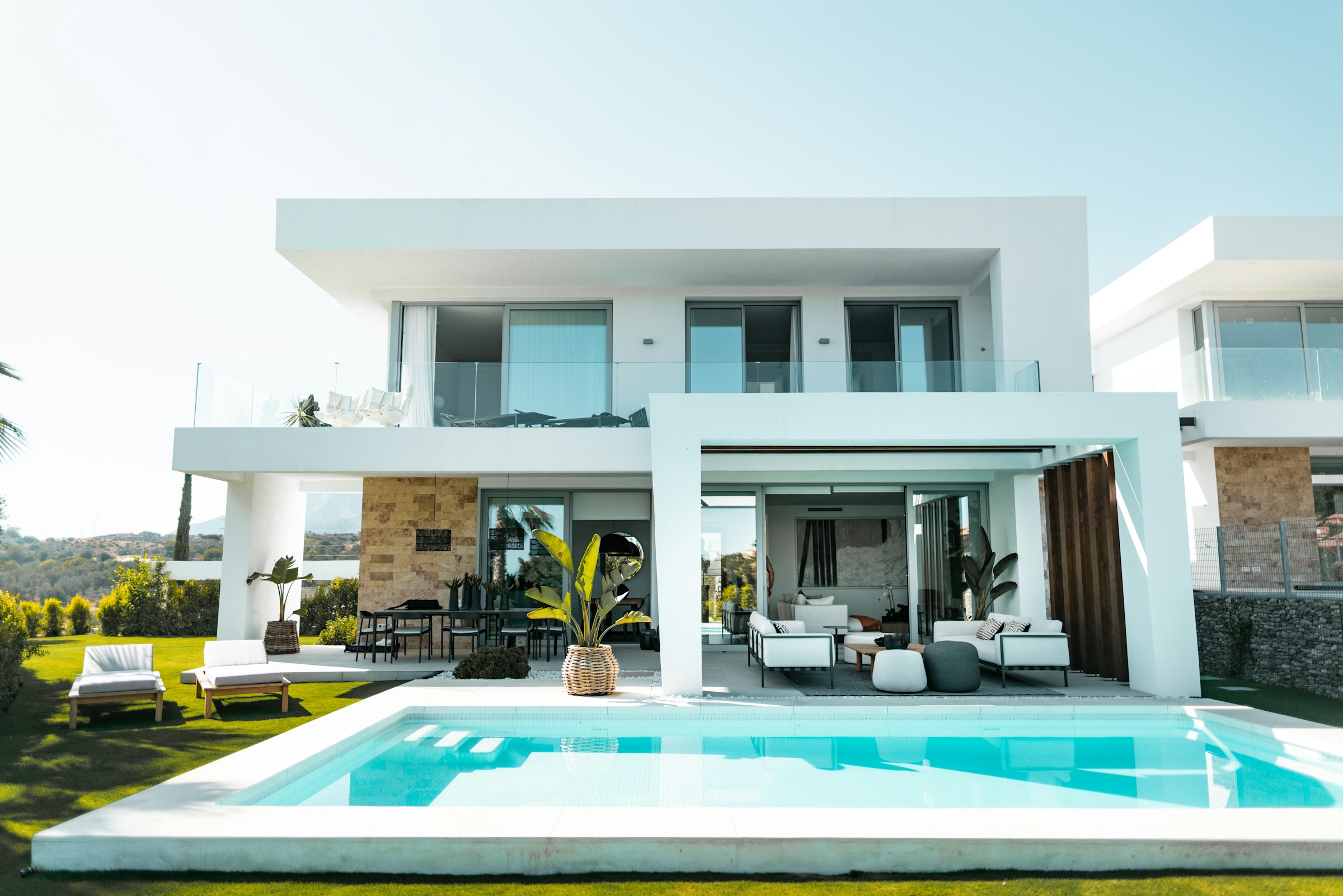 A sculptural white villa with a quiet swimming pool and natural stone architecture